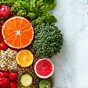 A vibrantly colored, artistic arrangement of fresh, healthy ingredients on a modern kitchen counter, symbolizing nutrition science